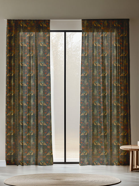 A sheer curtain panel featuring a repeating pattern of amber and forest green peacocks with botanical fan motifs on a dark background, creating a sophisticated Victorian gothic design.
